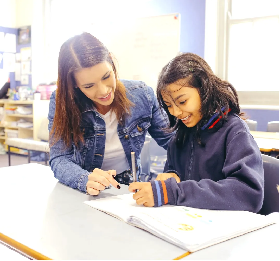 A mother teaching her daughter to write