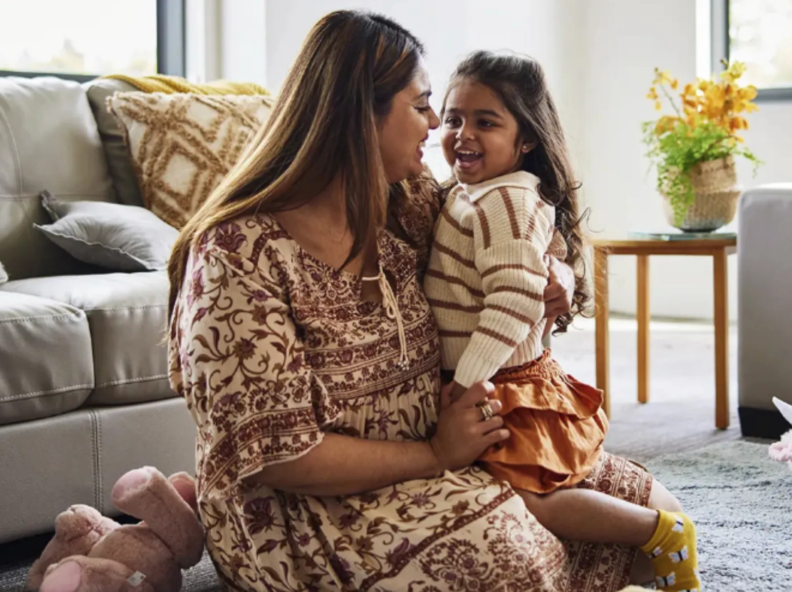 A mother and her daughter smiling